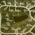 aerial image of retention pond in residential neighborhood