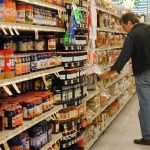 man shopping in a grocery store aisle