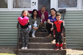 family poses for a front porch portrait as part of the Wethersfield PEP program