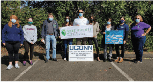 group of people wearing masks and holding signs
