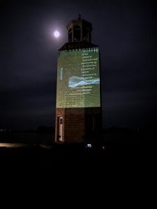 Image of"Reading the Wrack Lines" digital video projection on the UConn Avery Point Lighthouse