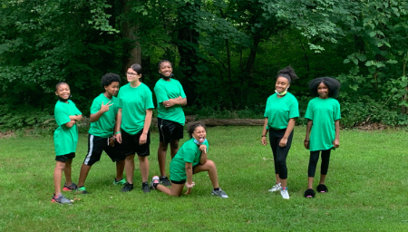 4-H dance squad members pose in the grass