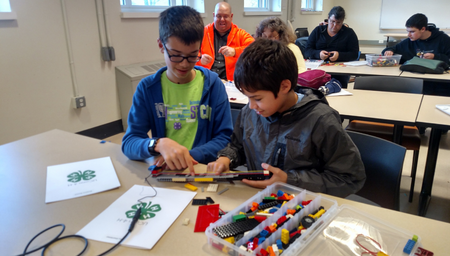 two boys working on a lego robotics project at a UConn 4-H program