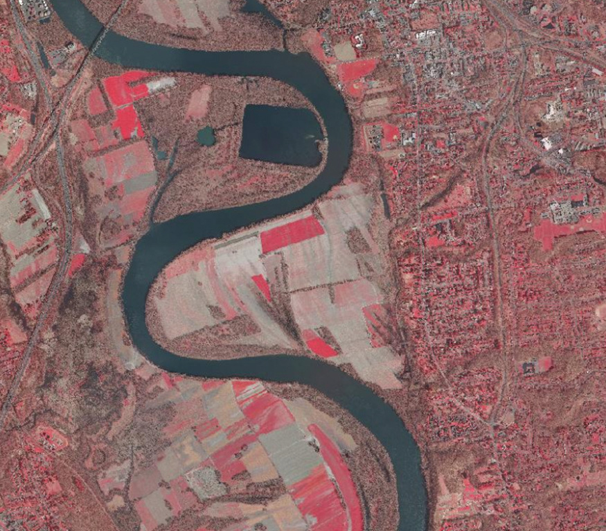 aerial map of Connecticut with river snaking through the middle and red sections showing higher population density