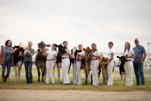 David Buck and Tamra French, UConn 4-H leaders, with members fo their 4-H club after the dairy show