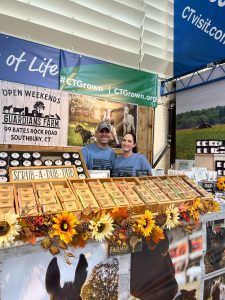 David Buck and Tamra French in the CT building at the Big E with their farm products