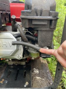 A person holding a cracked tube on a gas pump.
